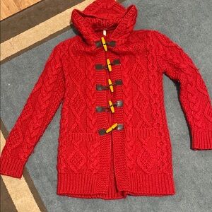 Heavy cable knit cardigan with toggles .